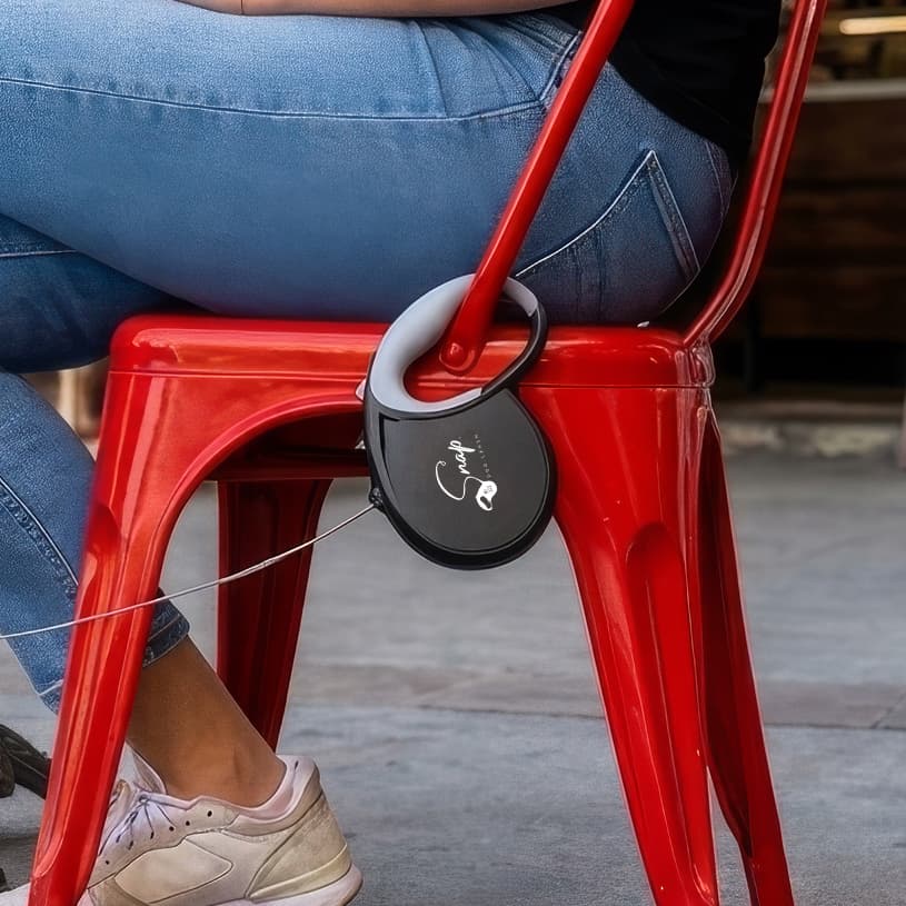 Snap Dog Leash retractable leash with built-in clip connected to a chair