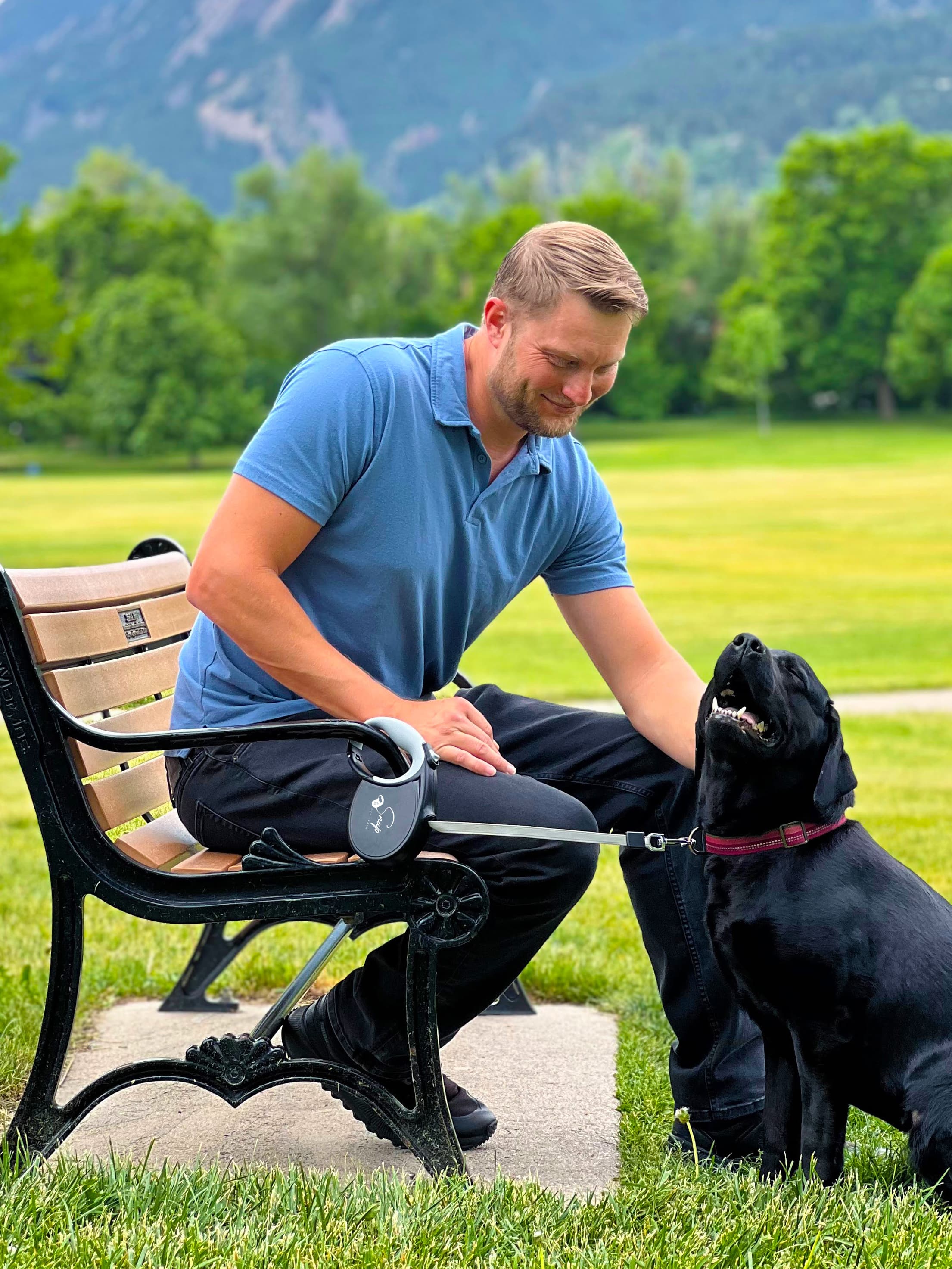 Man and dog enjoying a hands-free walk in the park with the Snap Dog Leash retractable dog leash with clip