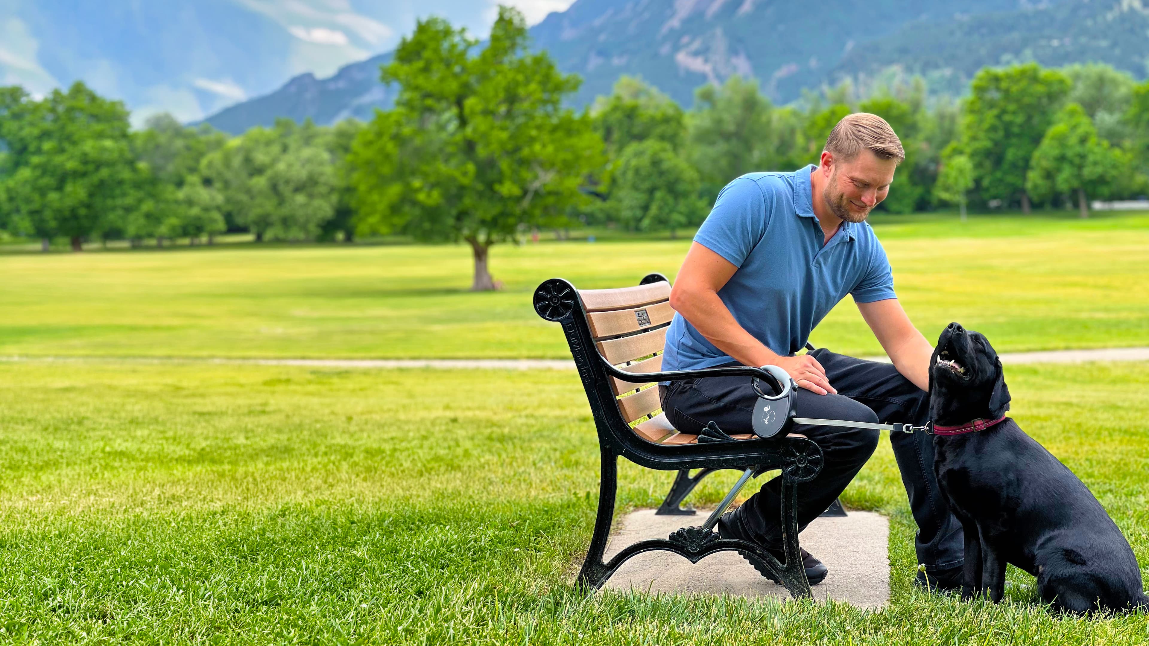 Man and dog enjoying a hands-free walk in the park with the Snap Dog Leash retractable dog leash with clip