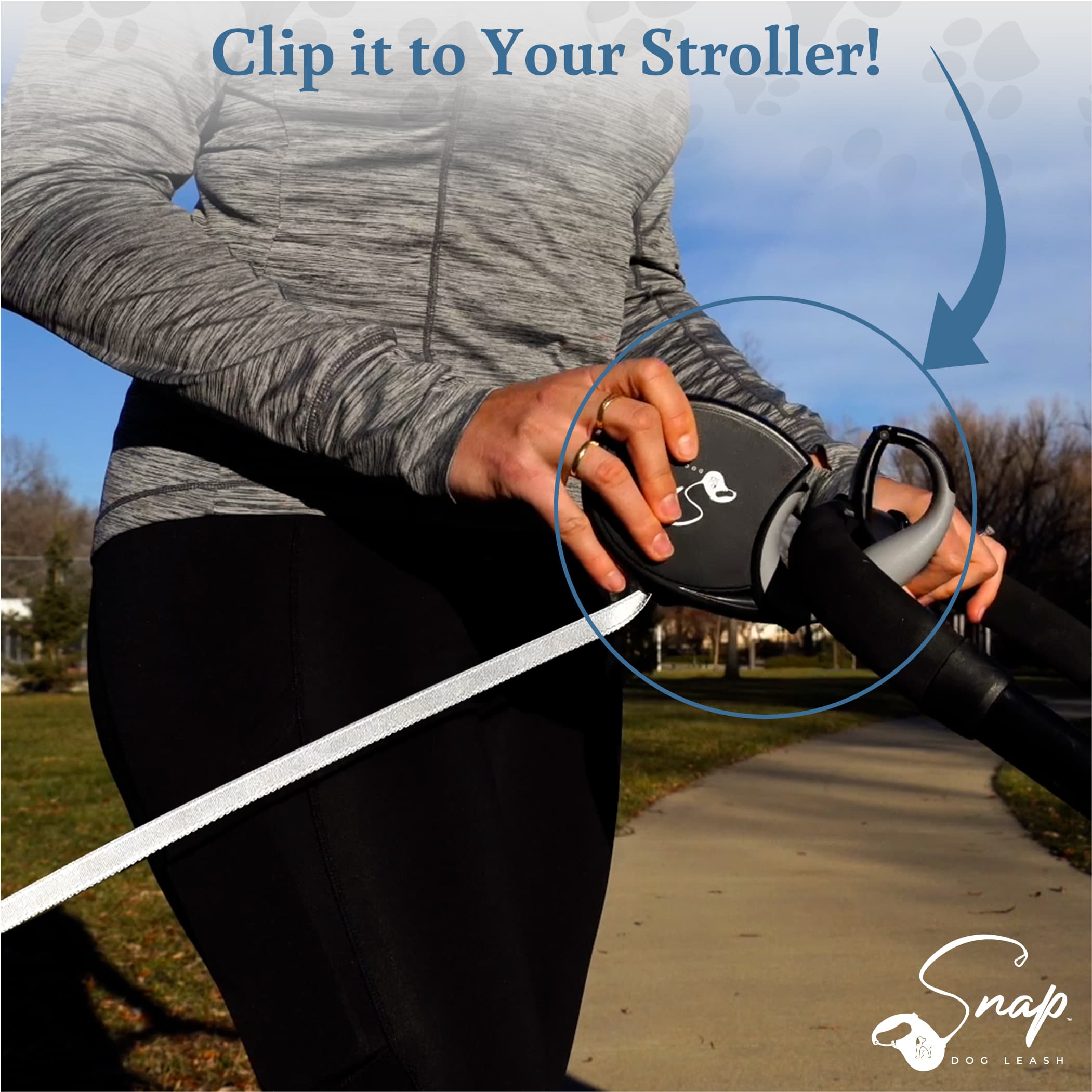 Retractable dog leash with clip attached to a stroller for hands-free walking