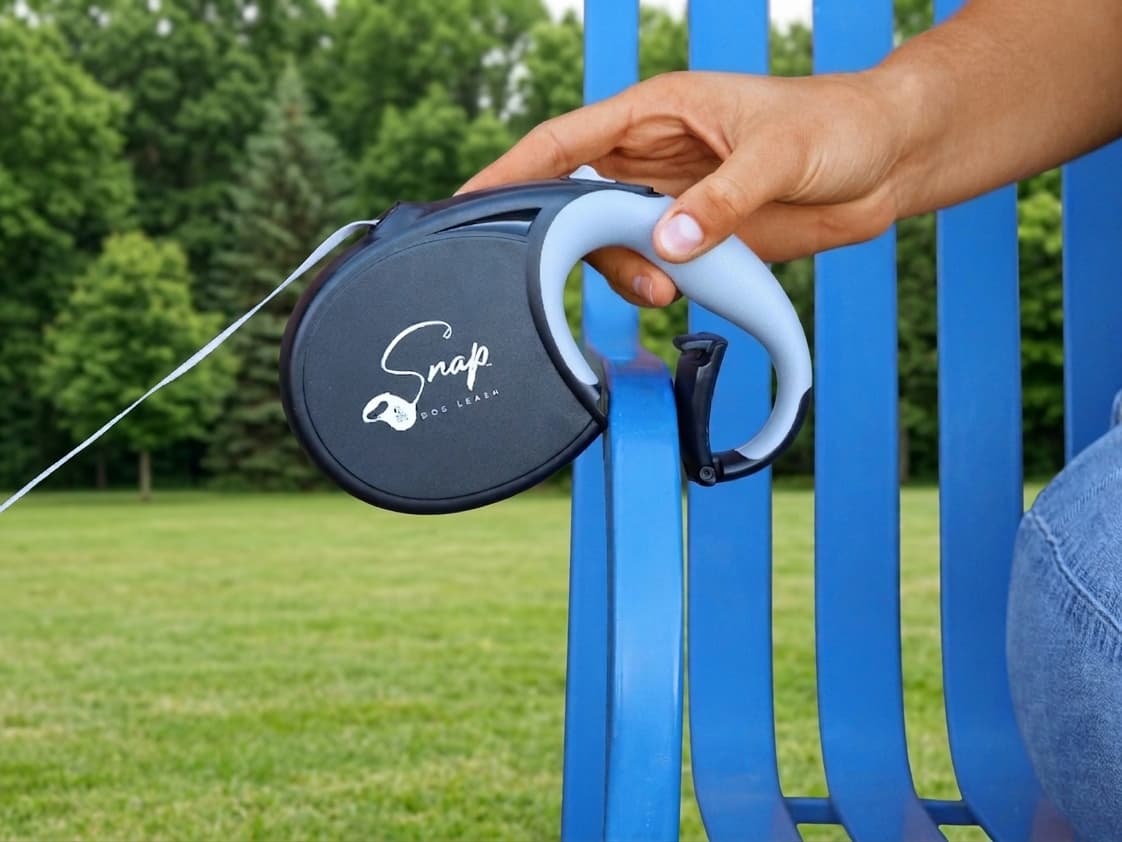 Built-in spring clip on the retractable dog leash opening over a park bench arm